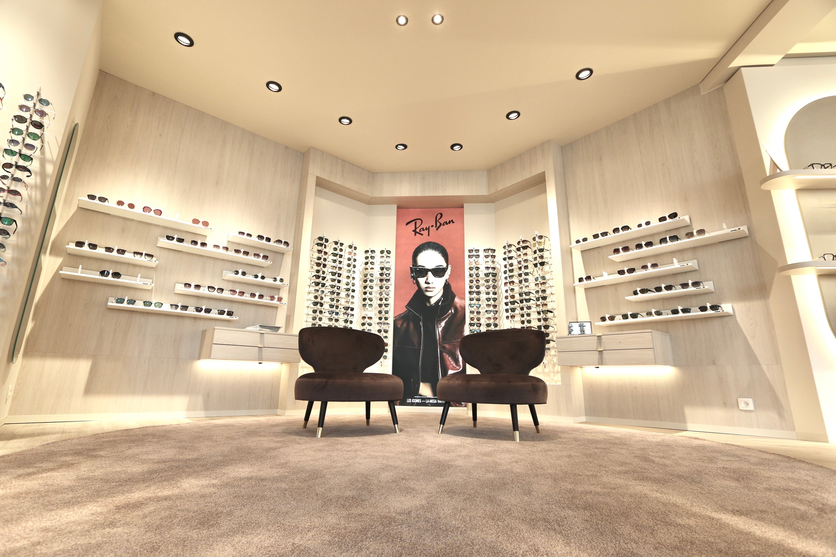 Optometry interior with eyewear display and eyewear presentations.