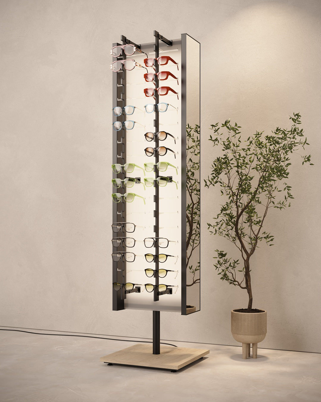 Freestanding eyeglass display stand with various eyeglasses next to a potted plant on a neutral background