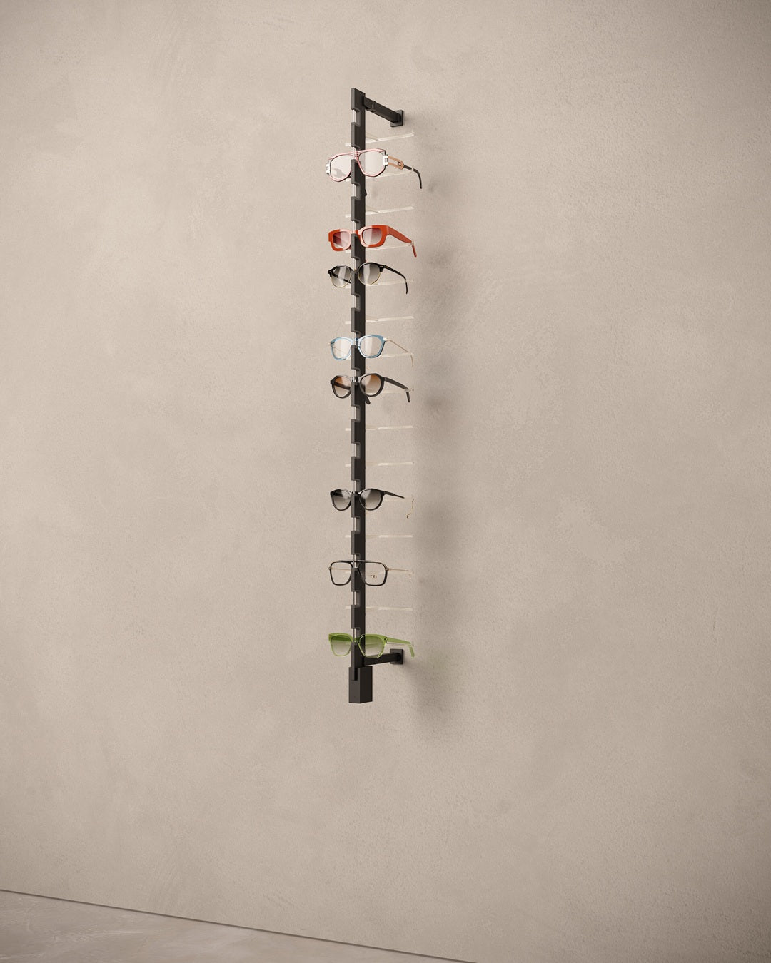 Sunglass display rack locked with multiple pairs of eyeglasses on a beige wall.