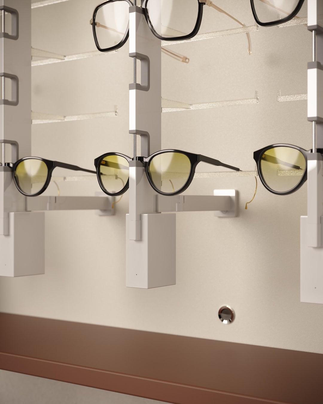 Eyeglasses displayed on a wall mount Sunglasses presentation cabinet against a neutral background