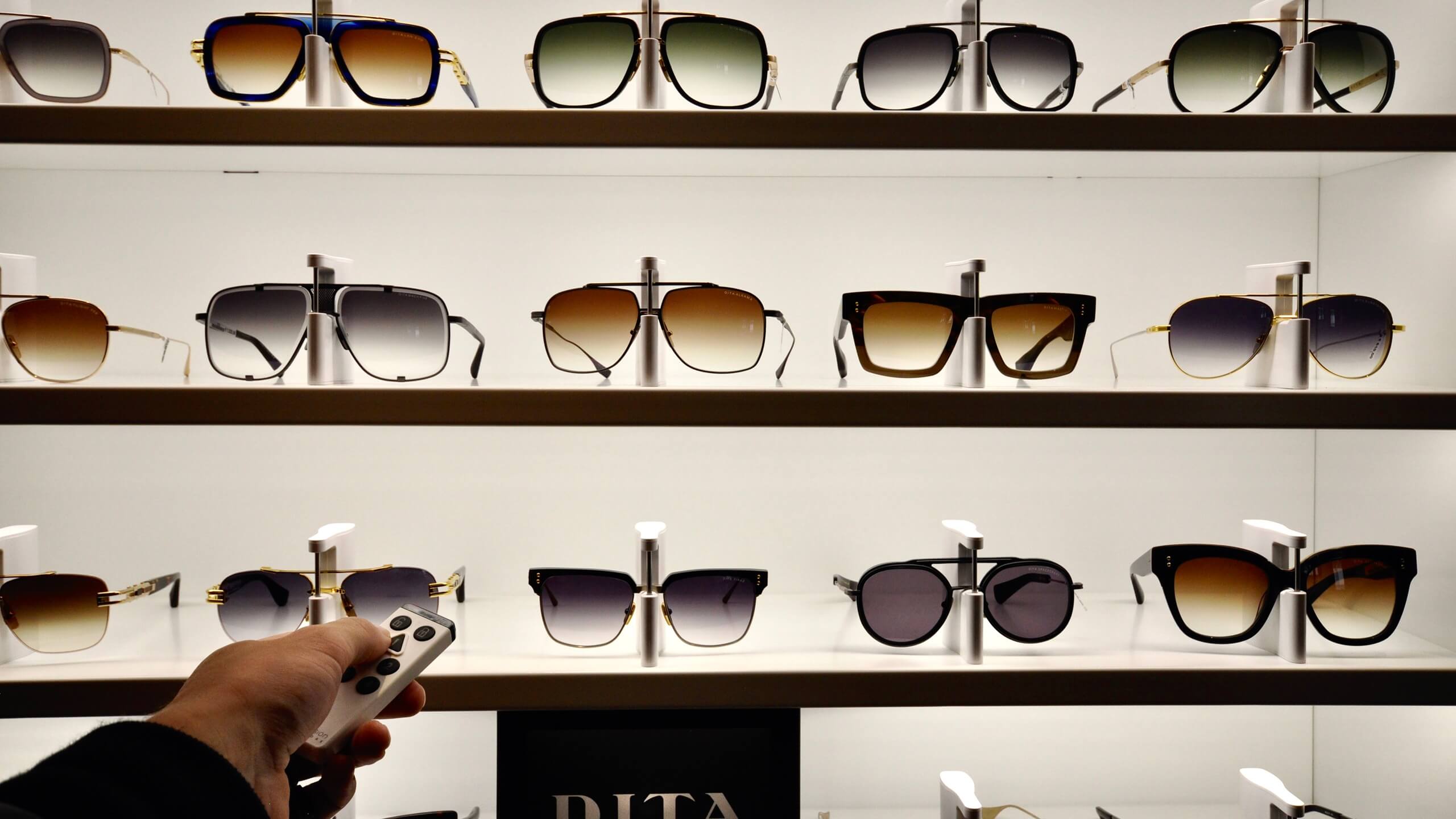 Eyewear cabinet locked with sunglasses on shelves with LED-light.