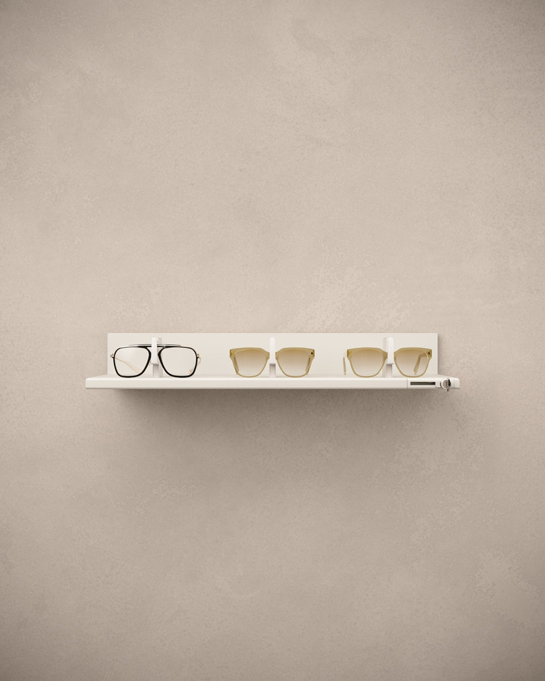 White eyewear shelf with eyeglasses on a beige wall