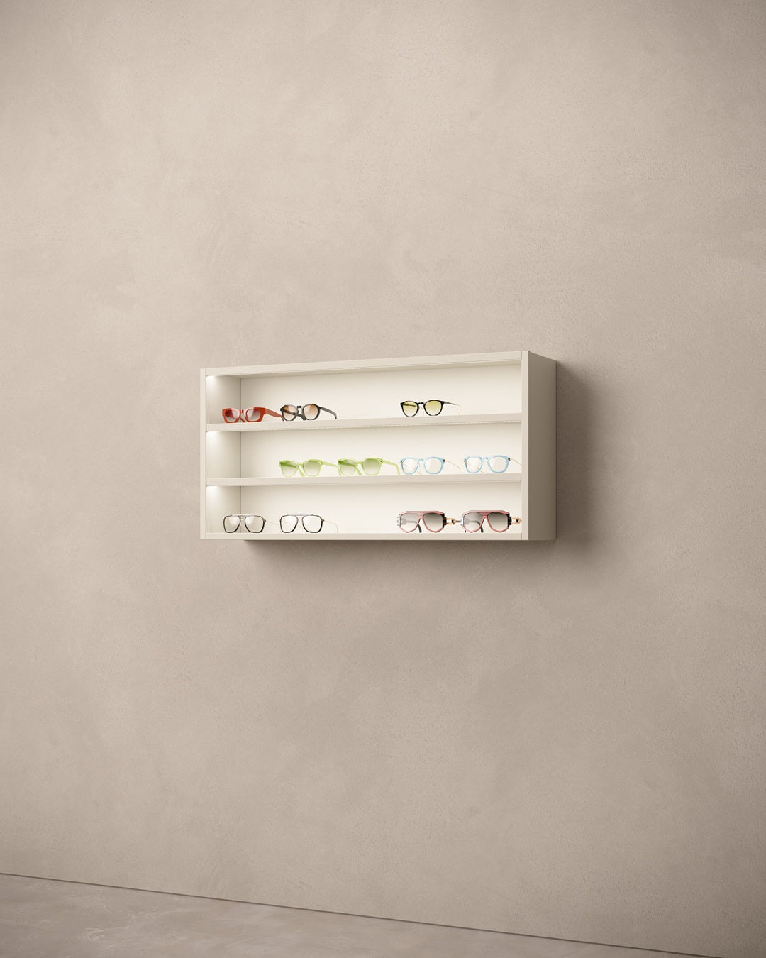 White wall-mounted illuminated display for eyeglasses with various items on a beige wall