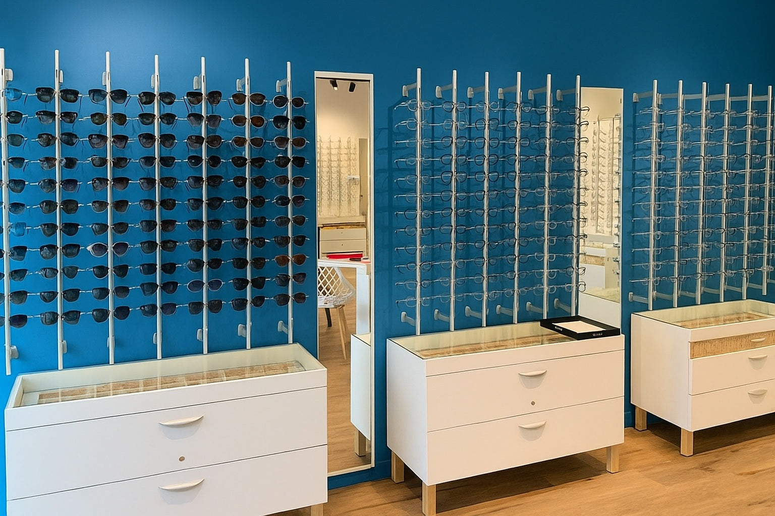 Optometry store with eyewear rods displaying eyeglasses against a blue wall.
