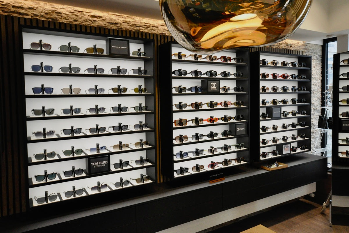 Lockable display cabinets with optical store lighting for various sunglasses in an optical store.